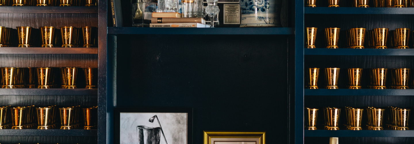 Decorative wall featuring metallic cups and artistic images of the south.